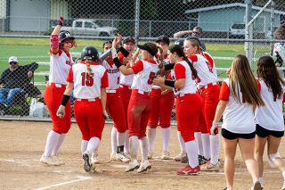 Nathan Ecker/News-Register##The Grizzlies crowd around home plate to welcome Ava Fleischman home after a home run versus Century. Fleischman hit another on Friday and leads the team in RBI with 24 while hitting .435.