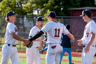 Rusty Rae/News-Register##Grizzly seniors Aaron Rolfe and Tyler Brummitt are welcomed back to the dugout by Cam Hyder during their home contest versus Liberty on Wednesday, May 6. Though dropping the game, all three upperclassmen were crucial on the bump and at the plate in beating the Falcons twice on their own turf.