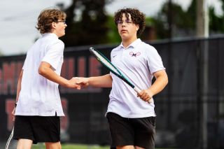 Rachel Thompson/News-Register##McMinnville sophomores Beckett Marksbury Page and Parker Williams shake hands after a point earned versus Newberg in No. 4 doubles play at Cowls Courts on Tuesday, March 5. The pair secured one of three match victories against an undefeated Tigers team, winning 2-6, 6-1, 6-3. Mac lost 3-6 as a team, but is hopeful about their positioning entering the district tournament on May 14.