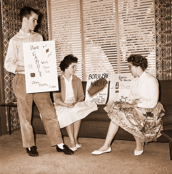 ## (May 2, 1961) Judged to be representative of safely posters prepared in a contest at McMinnville Junior High School, sponsored by the McMinnville Safety Council and the school PTA, were these done by (left to right) David Huston, Susan Keller and Diane Smith. Basis for the contest was to attain a higher goal of safety throughout the schools and the community.