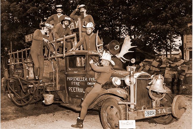 ##(May 4, 1956) Joining Grand Parade in Monmouth&rsquo;s centennial tomorrow will be this group of &ldquo;Smokeys&rdquo; from the &ldquo;Mooseholler Fyre Peetrol&rdquo; of McMinnville, that is, if they can get their new truck to roll. Getting it ready last night were, from left, Stan Thompson, Jim Joyce, Bob Fulham, Bary Hering, Henry Hering and Dale Pedersen, as they checked ladders, hoses and other equipment in the McMinnville Creamery yard.