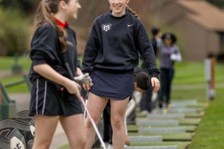 Rachel Thompson/News-Register file photo## Maria Burke shares a laugh with teammates on the Michelbook driving range before the Grizzlies first match of the season on Tuesday, March 17. All season, the team has done everything in their power to train together and boost each other s confidence before hitting the course on their own.
