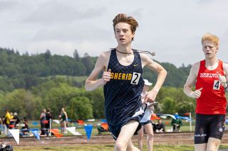 Nathan Ecker/News-Register##Zachery Dauvin runs the 1500-meter during the Amity Invitational. Fighting flu-like symptoms, Dauvin battled though sickness, chugging electrolyte drinks and water to replenish himself. Now healthier, Dauvin seeks to improve his times by a few seconds in what will be his final high school meets.