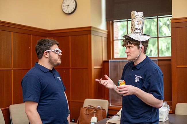 Rachel Thompson/News-Register##Shawn Mawdsley, sporting a handmade tinfoil top hat, chats with Cory Moonfall, wearing matching glasses. The pair co-founded MacApps LLC, a McMinnville-area software and web development startup that hosted the tinfoil hat-making event.