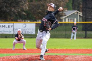 Nathan Ecker/News-Register##McMinnville junior Karson Vining rears back on a fastball delivery during his flawless start and 1-0 Grizzlies win versus Sherwood on Friday, May 15 at Patton Middle School. The junior recorded a save over the Bowmen on May 13 and returned two days later for the victory as a starter.