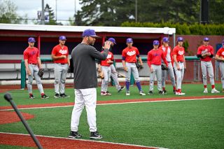 Photo courtesy of Zack Hampson##Coach Harlow speaks to the Linfield pitchers and the 
rest of the defense during a bunting drill in practice.