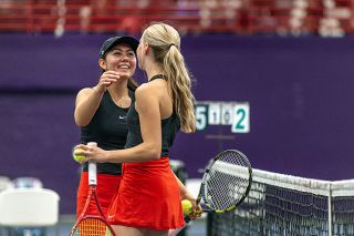 Nathan Ecker/News-Register##Madeleine Hendricks and Caroline Rickards bask in their two set victory over Sherwood&rsquo;s finals duo to win the girls doubles bracket at the Pacific Conference district tournament on Saturday, May 16, inside the Ad and Joan Rutschman Fieldhouse at Linfield University.