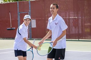Nathan Ecker/News-Register##Ewtai Bills and Brady Haught celebrate a match point on their way to a three set victory over a Newberg pair to take third place in the boys doubles bracket on Saturday, May 16.