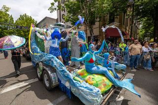 Rachel Thompson/News-Register##Members of The Saliens wave to spectators from their ocean-themed float while traveling east on Third Street past the Mack Theater during the UFO Festival parade on Saturday, May 17. The group won the parade&rsquo;s Best Float award as thousands gathered downtown for the annual festival celebrating McMinnville&rsquo;s famous 1950 UFO sighting.