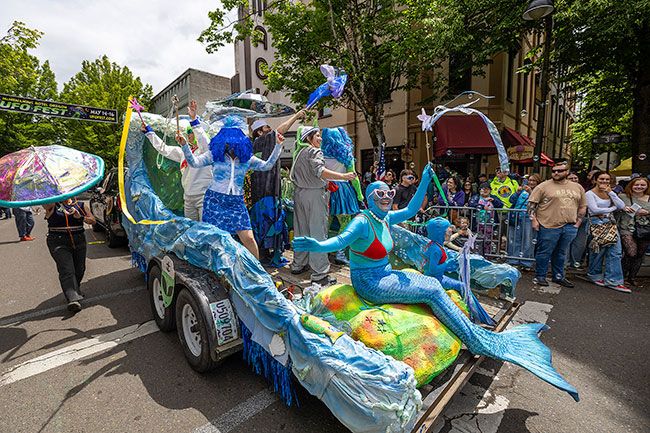 Rachel Thompson/News-Register##Members of The Saliens wave to spectators from their ocean-themed float while traveling east on Third Street past the Mack Theater during the UFO Festival parade on Saturday, May 17. The group won the parade&rsquo;s Best Float award as thousands gathered downtown for the annual festival celebrating McMinnville&rsquo;s famous 1950 UFO sighting.