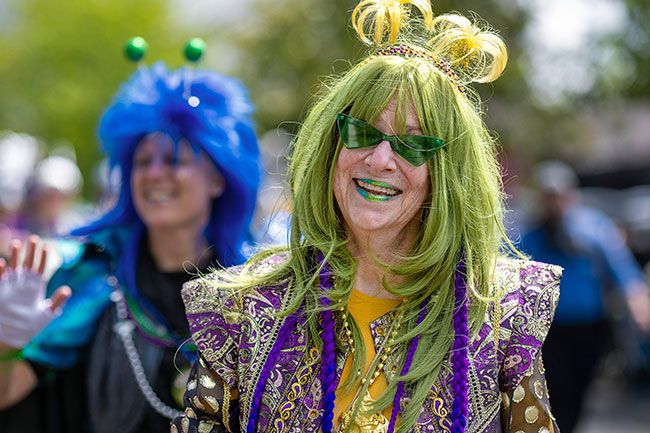 Rachel Thompson/News-Register##Kathy Ware, Queen Nimbus II of the Portland-based Misty Krewe of Nimbus, greets spectators while marching in the parade.