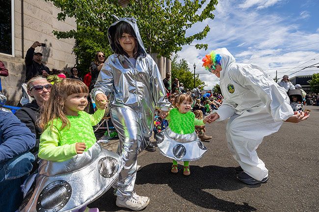 Rachel Thompson/News-Register##Holly Nelson, right, chief workforce innovation officer at Chemeketa Community College, breaks away from the college&rsquo;s parade group to dance with 2-year-old cousins Vivi Haggith and Clara Preciado, alongside Katie Stewart.