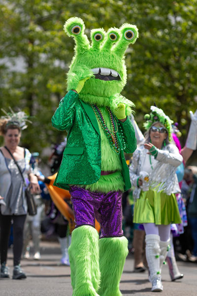 Rachel Thompson/News-Register##A four-eyed alien from the Mysti Krewe of Nimbus dances down Fourth Street during the UFO Festival parade.