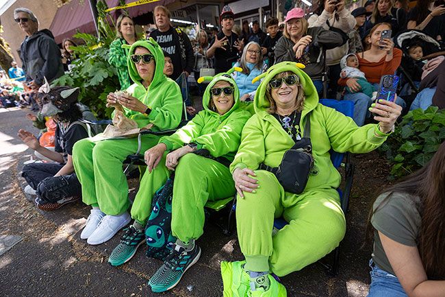 Rachel Thompson/News-Register##Susan Duncan of McMinnville, center, is joined by friends Kathy Tabor of Hillsboro, left, and Marcy Bee of Bend while watching the parade in matching alien onesies.