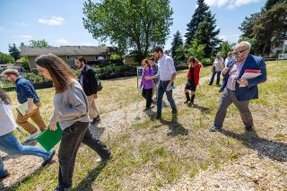 Rachel Thompson/News-Register##U.S. Rep. Andrea Salinas talks with Nathan Wildfire, Missing Middle Housing Fund co-founder and CEO, during a site tour of the future workforce housing development in Newberg called HIVE.