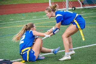 Emily Bonsant/News-Register##Adie Nisly helps up her twin sister Eliza Nisly up after a touchdown reception. Eliza fought in the air with a Tualatin defender as the Warriors trailed 20-19 with 35.9 seconds left in the game.