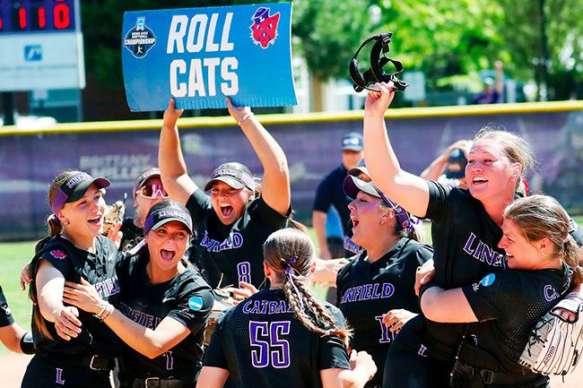 Photo courtesy of Kelly Bird, Linfield Athletics##Wildcats&rsquo; senior catcher Ashlyn Aven holds up her pitcher, junior Tyler McNeley, as Linfield celebrates its trip to the NCAA College World Series with a victory over Moravian University on Friday, May 22, at Del Smith Stadium.