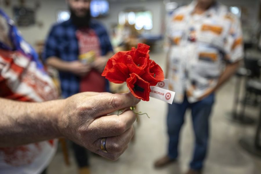 Rachel Thompson/News-Register##Glenn Smith of McMinnville holds a bundle of memorial poppies during Monday&rsquo;s Memorial Day gathering. Darla Gregory of McMinnville distributed the flowers for donations supporting veterans programs and honoring POWs, MIAs and fallen service members. &ldquo;Wear it with pride,&rdquo; Gregory said. &ldquo;That&rsquo;s what I tell everybody.&rdquo;