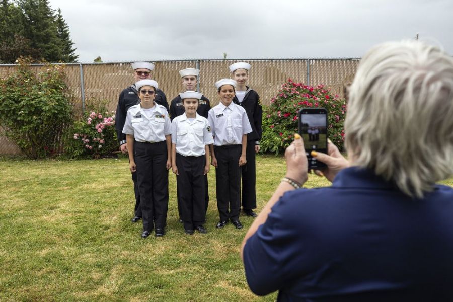 Rachel Thompson/News-Register##Sea Cadets Executive Officer Lori Qualls, right, photographs a group of Sea Cadets during a Memorial Day gathering Monday at the McMinnville American Legion Post 21. Earlier in the day, the cadets served as color guard during ceremonies at area cemeteries before concluding at the Legion post, where a community barbecue followed. Pictured are, front row from left, Ayla Uscanga, Kenzie Timmons and Lorenzo Lara, and back row from left, Liam McPeters, Zane Brubaker and Bryson Vorderstrasse.