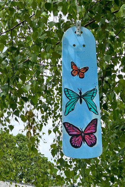 Kirby Neumann-Rea/News-Register##Ceiling fan paddles repurposed as adornments hanging from a maple.