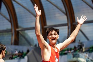 Nathan Ecker/News-Register##McMinnville senior Brain Lewis raises his arms with joy toward the Grizzly cheering section after finishing fourth in the 6A boys&rsquo; 110-meter hurdles final.