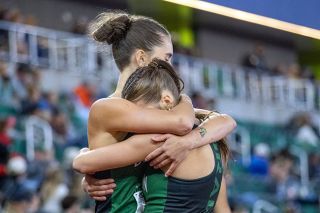 Nathan Ecker/News-Register##Delphian senior Liv Curry and sophomore Lily Olivares envelop one another, sharing in the moment that each earned a podium placement after running in the final heat of the girls&rsquo; 300-meter hurdles during the second day of competition at the 2A State Track and Field Championships inside of Hayward Field in Eugene. It was the second-to-last time they ran side-by-side, later competing as the first and last leg of the 4x400-meter relay.