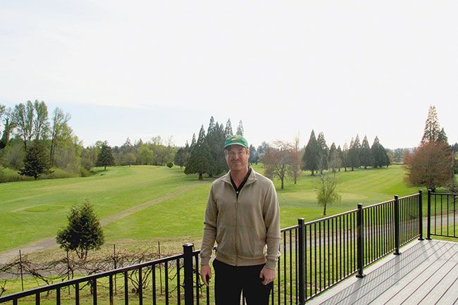 Photo courtesy of Cade Welch##Owner Josh Kay standing on the Preserve balcony with the course behind.