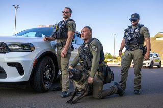 Rachel Thompson/News-Register##YCSO K-9 handlers (left) Colton Waker, Chris Bannister and Jeramiah Baker run through a training scenario with 1-year-old Dutch Shepherd apprehension K-9 Koa in the parking lot at the Evergreen Aviation and Space Museum.