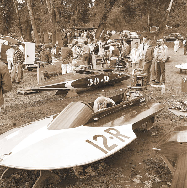 ##(June 2, 1961) Crowd at the Newberg Boat Races mills around two of the boats that competed in the 13th annual running Tuesday afternoon on the Willamette River. More than 1000 spectators lined the banks of the Willamette to view the colorful races.