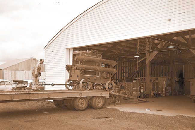##(June 2, 1956) Roswell Rossner, McMinnville Fire assistant chief, checks a cable from a winch while loading a mobile pump onto a state highway department truck for transportation to flood-threatened areas in Portland. The pump, capable of pumping 1500 gallons of water a minute, is part of civilian defense equipment stored at the McMinnville airport and maintained by the fire department.
