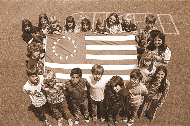 ##(June 4, 1976) Sixth graders in Sybil Seward&rsquo;s class at Dayton Grade School worked secretly on their bicentennial project as a surprise gift to the school. Project was a &ldquo;Betsy Ross&rdquo; flag. The 13 stars were hand sewn by students to the 3&rsquo;x5&rsquo; flag. Students used the password &ldquo;needles and pins&rdquo; to enter the room when students were sewing. The 27 students involved held a bake sale to finance materials. Flag now hangs in the entry hall of the grade school.