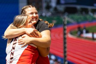 Nathan Ecker/News-Register##Brooklyn Johnston and Ruby Riddle share an embrace on the discus podium at the 6A Track and Field State Championships at Hayward Field in Eugene on Saturday, May 30. Their respective eighth and second place finishes in the event marked the final time either senior competed in a Grizzly uniform.