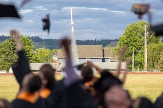 Nathan Ecker/News-Register##A rocket assembled by Yamhill Carlton co-valedictorian Lucas Partin blasts into the sky Friday, June 5, as graduates throw their mortarboards up in unison. The moment symbolized the Tigers finally taking off into a new stage of life.