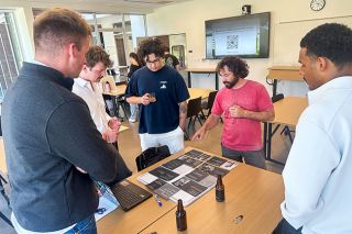 Kirby Neumann-Rea/News-Register##Grain Station brewer (and 2011 alumni) Joe D&rsquo;Aboy, second from right, discusses Belgian strong ale with team members, right to left, Kenyon Johnson, Cade Johansen and Connor Moholovitch, all Linfield seniors, at the Chem 400 tasting. At center is Max Clanton, also Class of &lsquo;26.