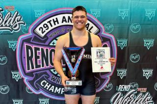 Photo courtesy of Willamina Wrestling##Incoming Willamina senior Landon Risseeuw poses for a photograph with the Eagle, a trophy handed out to an All-American every year at the Reno World Championships. Risseeuw earned the trophy by testing himself against a gauntlet of heavy weight wrestlers from all across the west coast. He hopes to add a 3A State Championship trophy to his mantle next.
