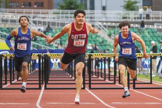 Nathan Ecker/News-Register##Chinchilla (center) stretches over the finish line in the boys&rsquo; 110-meter hurdles, beating out fellow PacWest Conference foes Deontae Washington (left) and Carson Smith (right) from Blanchet Catholic. Chinchilla&rsquo;s time of 15.57 beat both runners by more than half a second.