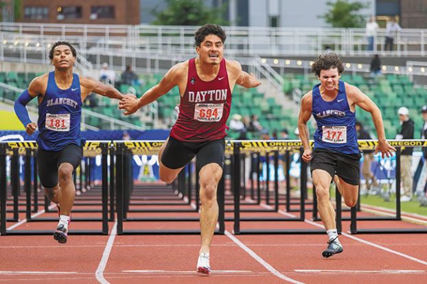 Nathan Ecker/News-Register##Chinchilla (center) stretches over the finish line in the boys&rsquo; 110-meter hurdles, beating out fellow PacWest Conference foes Deontae Washington (left) and Carson Smith (right) from Blanchet Catholic. Chinchilla&rsquo;s time of 15.57 beat both runners by more than half a second.