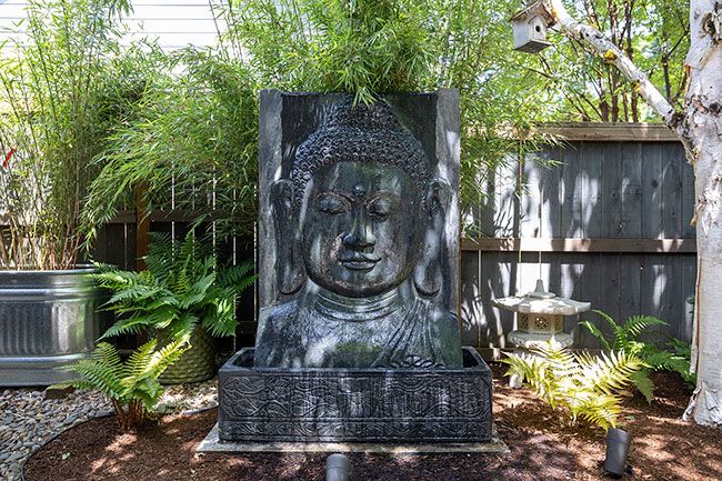 Rachel Thompson/News-Register##One of the many Buddhas in the space doubles as a water feature. The trickling fountain provides background music.