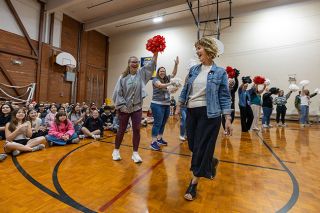 Rachel Thompson/News-Register##Memorial Elementary School Principal Kim Price enjoys her walk through a gauntlet of pompom waving staff members as they celebrate her impending retirement. Price said she loved the way her school honored her. &ldquo;My own little parade!&rdquo; she said.