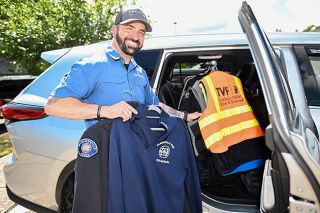Rusty Rae/News-Register##&ldquo;Hope Chaplain&rdquo; Leo Keelan carries a wardrobe of shirts from the various agencies with which he works &mdash; McMinnville and Amity fire departments, McMinnville police, Yamhill County Sheriff&rsquo;s Office and others &mdash; so he can arrive at the scene in appropriate attire. Chaplain Keelan said he finds it rewarding to help people in their darkest moments. In addition to assisting families following traumatic incidents, he works with first responders to help them deal with the emotional stress of their work.
