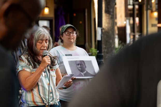 Rusty Rae/News-Register##DEIAC member Katherine Martin reads &ldquo;Sympathy&rdquo; by Paul Laurence Dunbar while Caitlin Nemeth holds a photo of the writer. The poem&rsquo;s opening line was the inspiration for the title of Maya Angelou&rsquo;s famous autobiography, &ldquo;I know Why the Caged Bird Sings.&rdquo;