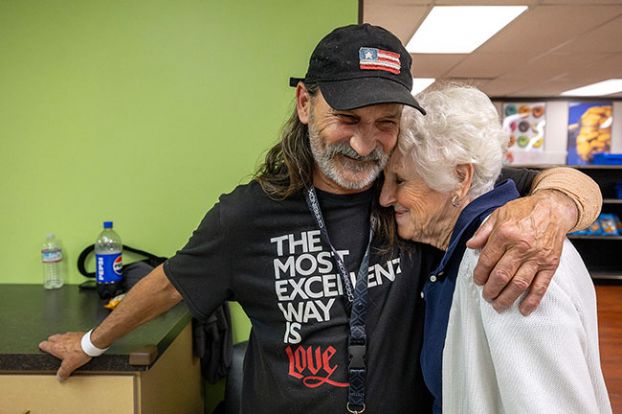 Rachel Thompson/News-Register##Mary Kaye Stephens, a longtime volunteer at Hope on the Hill, hugs Jack Pettit, a Hope House resident who helps at the food bank weekly. Pettit said moving into Provoking Hope&rsquo;s residential program almost a year ago changed his life for the better, and he enjoys doing community service to assist others.