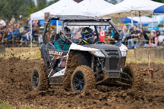 Nathan Ecker/News-Register##Traci Hamilton of Sheridan in a 2018 Textron Wildcat Trail XT roars through thick mounds of mud while competing in the side-by-side drag races. Outside of the short course, the utility task vehicles were also given spots in the drag races themselves, offering incoming racers more opportunities to compete. The UTV races were pitched after Willamina Mud Drag organizers witnessed the event elsewhere. They became an ultimate favorite among the crowd, who were glad they stayed till the end to see the high-octane action.