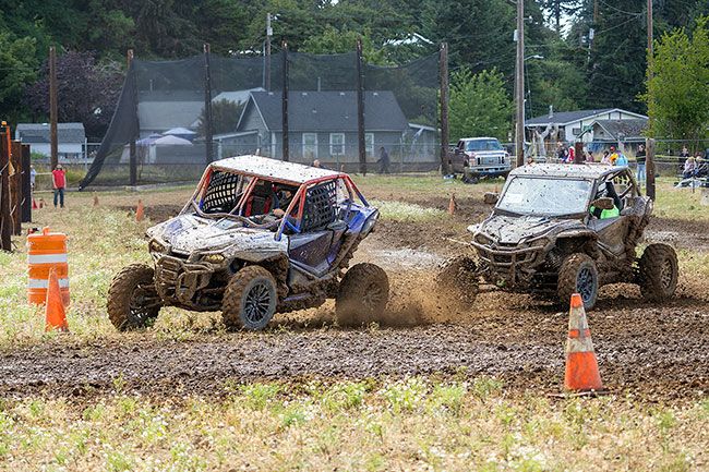 Nathan Ecker/News-Register##Steven Brown jumps ahead of another racer driving a black Honda Talon. Contestants in the side-by-side started on the drag strip and were forced to shift into a sharp right turn to begin the course. Those who reached the opening turn first often won the race.