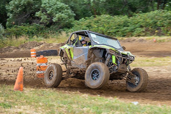 Nathan Ecker/News-Register##Himes drifts around the first corner of the short course, leaving mud splatter in the wake of his 2019 Honda Talon.