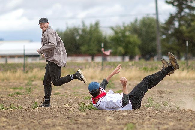 Rachel Thompson/News-Register##Gristmiller baserunner William &ldquo;Fly Guy&rdquo; Alden eludes second baseman Jordan &ldquo;Danjo&rdquo; Anderson of the Boilermakers, who tumbled while fielding a grounder on the bumpy hayfield recently harvested and turned into a diamond.