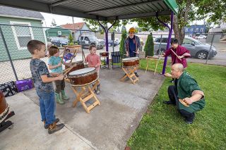 Rachel Thompson/News-Register##Audience volunteers join Unit Souzou performers Toru Watanabe, foreground right, and ManMan Mui for a taiko drumming lesson.