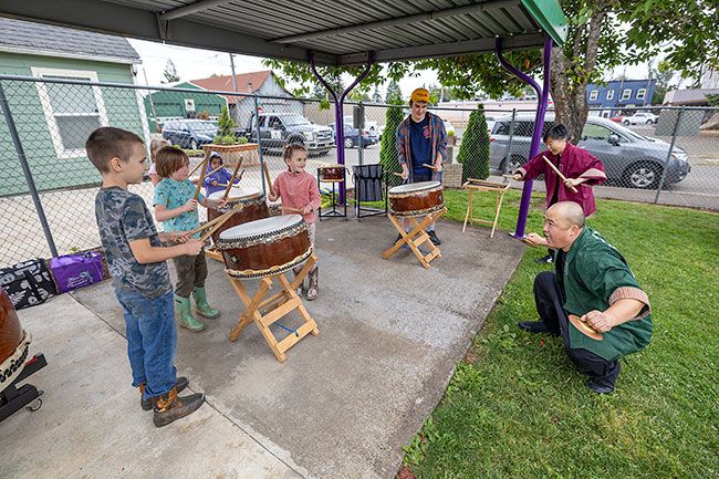 Rachel Thompson/News-Register##Audience volunteers join Unit Souzou performers Toru Watanabe, foreground right, and ManMan Mui for a taiko drumming lesson.