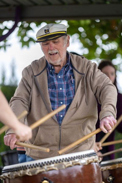 Rachel Thompson/News-Register##Craig Johnson of Willamina tries his hand at the hirado daiko, a shallow-bodied taiko drum, during the program&rsquo;s audience participation finale.