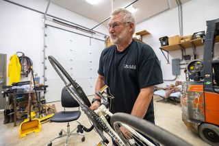 Rachel Thompson/News-Register##In his garage workshop in Dayton, Cecil Elbert talks about the bicycle he built in 1976 for a cross-country Bicentennial ride with three companions.